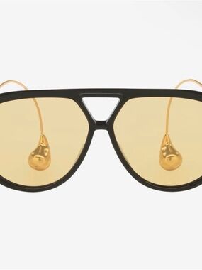 Bottega Veneta Black Frame Sunglasses with Gold Accents and Amber Lenses